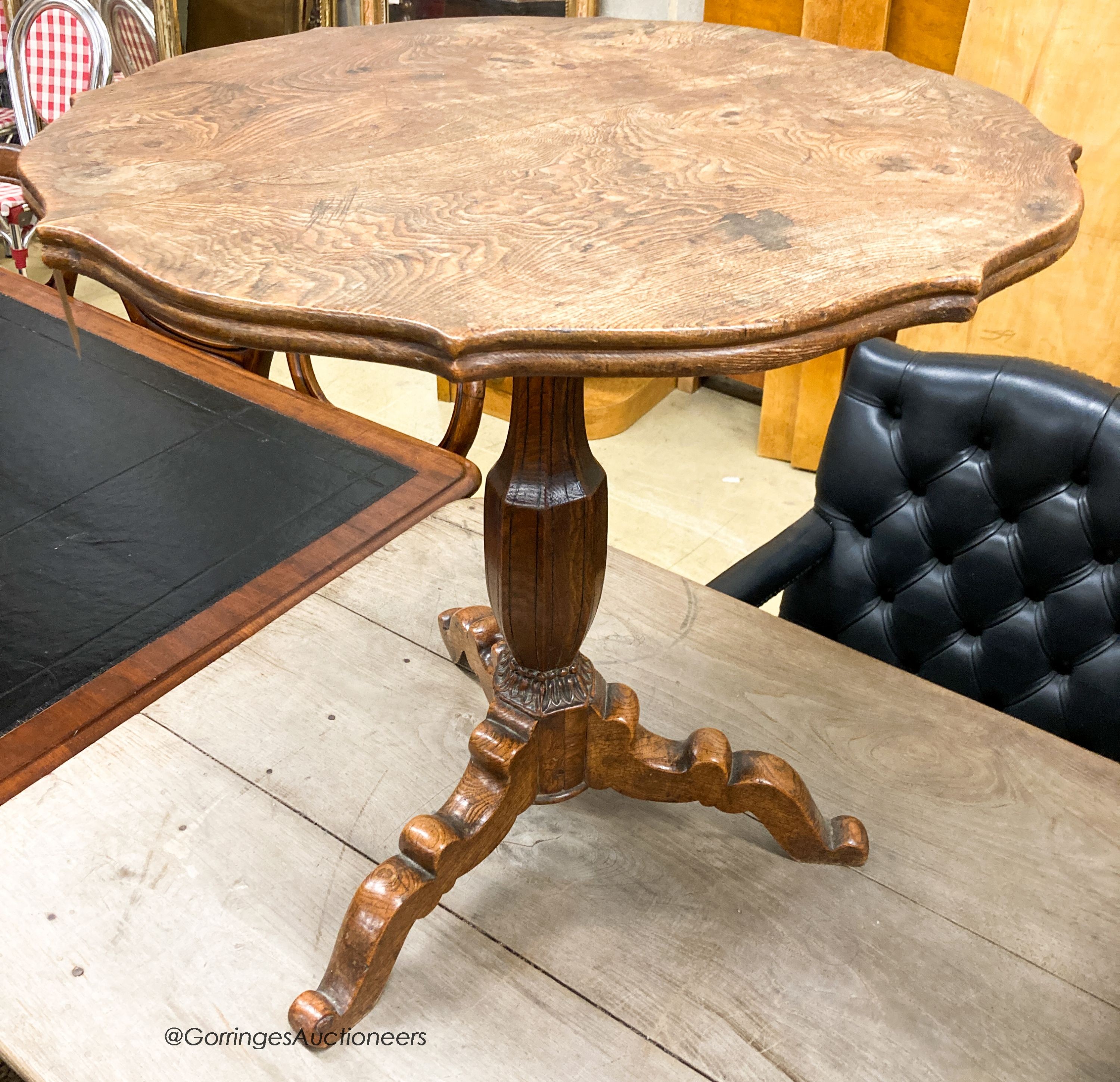 An early 20th century circular oak tripod table, W.67cm H.69cm